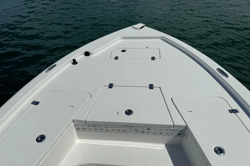 Slide: The Image of 2016 Sea Hunt BX 20 BR boat deck with storage compartments on calm water. - 21