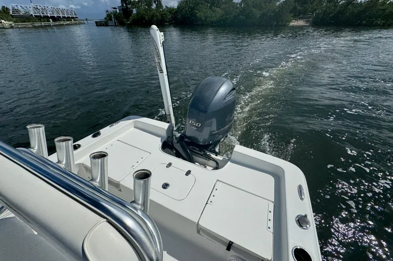 Slide: The Image of 2016 Sea Hunt BX 20 BR boat with outboard motor on a calm waterway. - 24