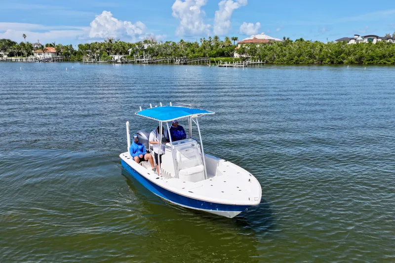 Slide: The Image of 2016 Sea Hunt BX 20 BR boat cruising on a sunny day with two passengers. - 7