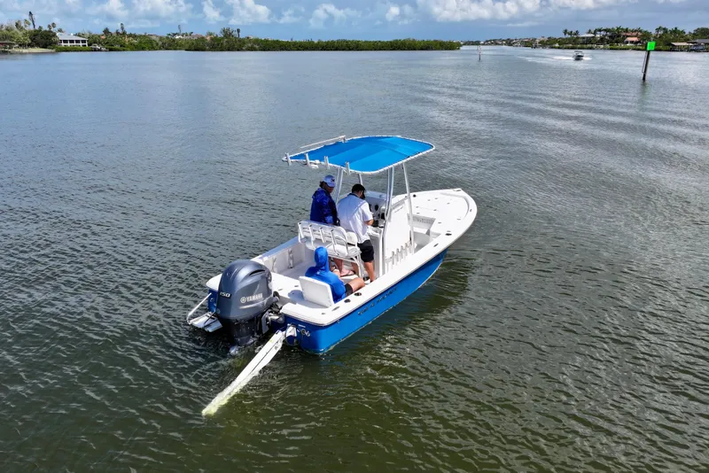 Slide: The Image of 2016 Sea Hunt BX 20 BR boat cruising on a calm waterway with two passengers. - 9