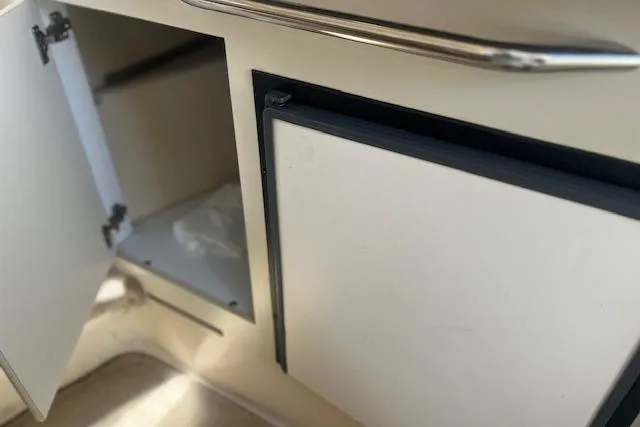 Slide: The Image of Interior storage compartments on a 2000 Sea Ray 270 Sundancer boat. - 14