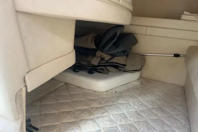 Slide: The Image of Interior cabin of 2000 Sea Ray 270 Sundancer with storage and cushions. - 16