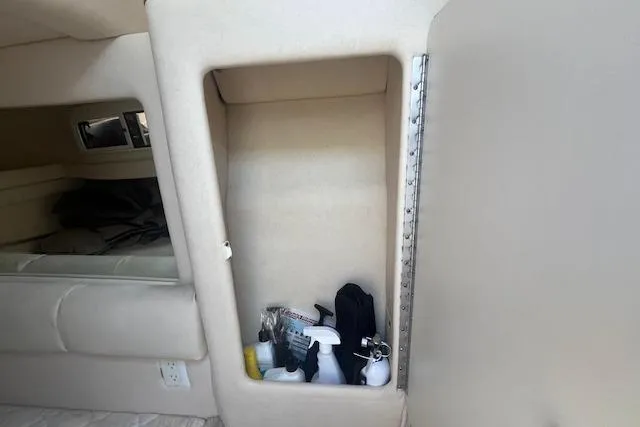 Slide: The Image of Interior storage compartment on a 2000 Sea Ray 270 Sundancer boat with cleaning supplies. - 17