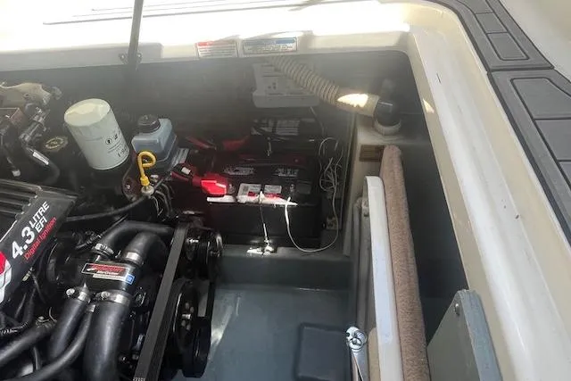 Slide: The Image of Engine compartment of a 2000 Sea Ray 270 Sundancer boat, showing a 4.3L engine and battery. - 18