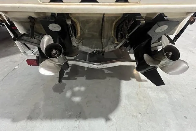 Slide: The Image of 2000 Sea Ray 270 Sundancer boat stern with dual propellers in a garage setting. - 23