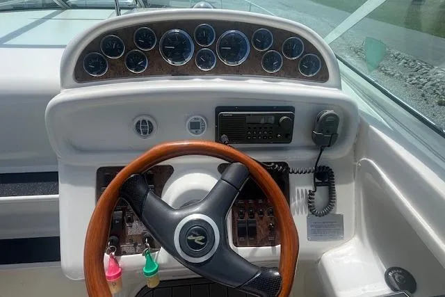 Slide: The Image of Cockpit of 2000 Sea Ray 270 Sundancer with wooden steering wheel and instrument panel. - 4