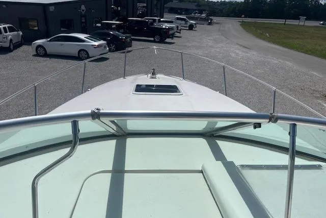 Slide: The Image of 2000 Sea Ray 270 Sundancer boat docked, view from bow, in a parking area. - 5