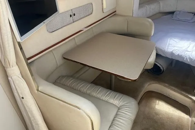 Slide: The Image of Interior of 2000 Sea Ray 270 Sundancer with dining area and seating. - 9