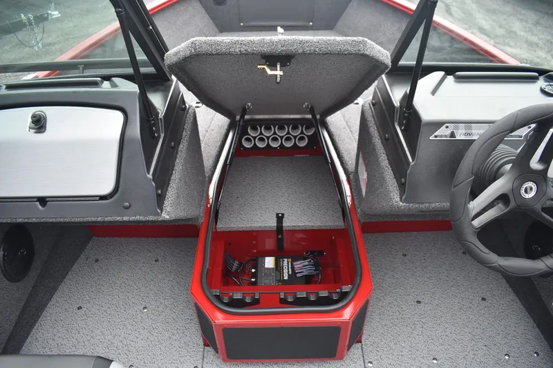 Slide: The Image of 2026 Lund 1775 Adventure Sport boat interior with open storage compartment and steering wheel. - 11