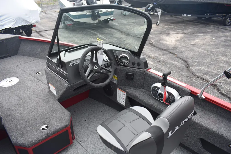 Slide: The Image of 2026 Lund 1775 Adventure Sport boat interior with steering wheel and control panel. - 8