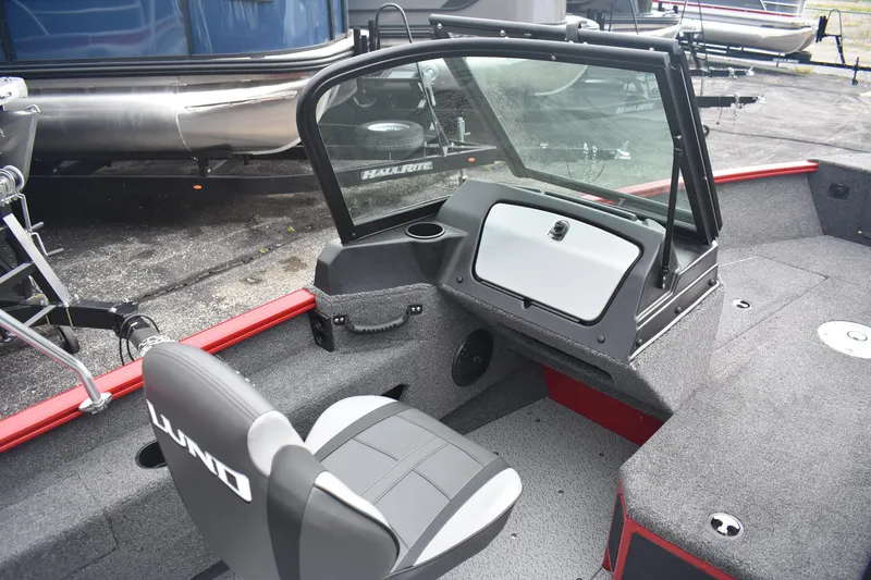 Slide: The Image of 2026 Lund 1775 Adventure Sport boat interior with seating and windshield, showcasing modern design. - 9