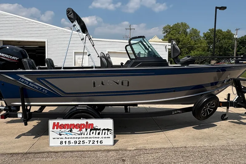 The Image of 2026 Lund 1875 Impact XS Sport boat displayed at Hennepin Marine dealership. - 1