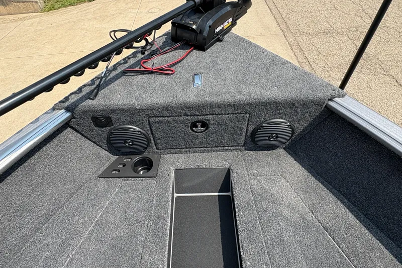 Slide: The Image of 2026 Lund 1875 Impact XS Sport boat interior with speakers and trolling motor. - 11