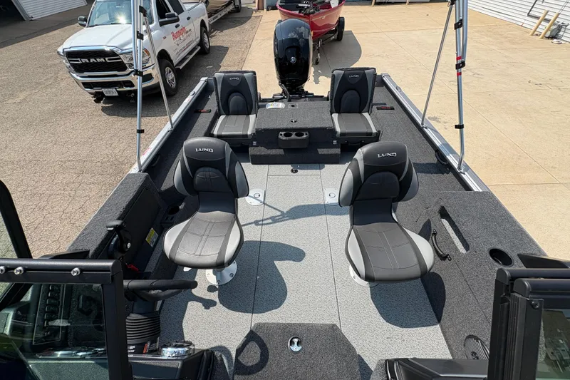 Slide: The Image of 2026 Lund 1875 Impact XS Sport boat interior with seating and fishing setup. - 15