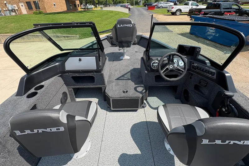 Slide: The Image of 2026 Lund 1875 Impact XS Sport boat interior with seating and dashboard view. - 17