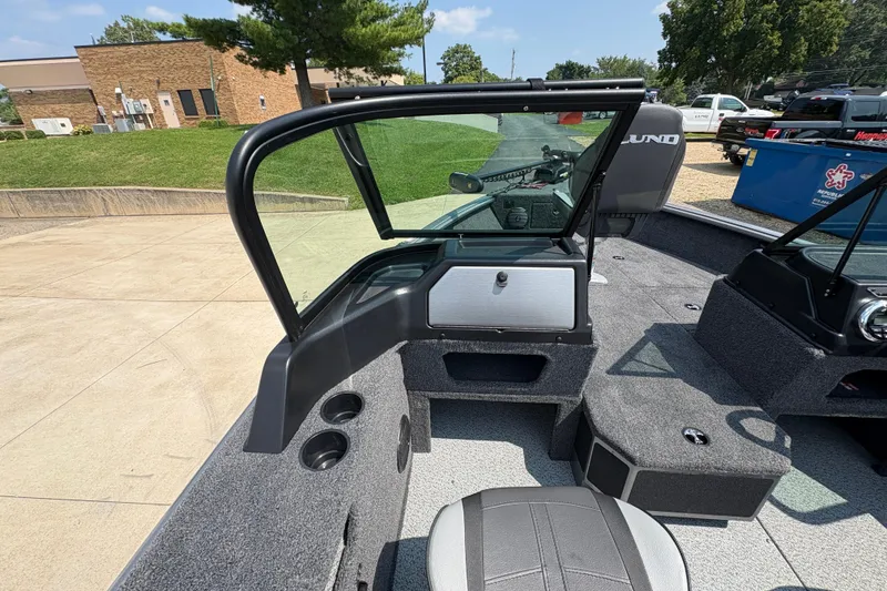 Slide: The Image of 2026 Lund 1875 Impact XS Sport boat interior with seating and windshield. - 18