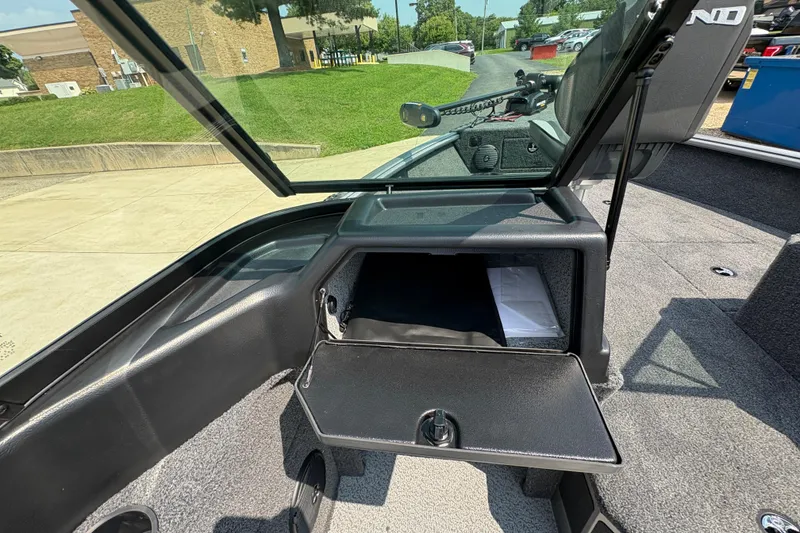 Slide: The Image of 2026 Lund 1875 Impact XS Sport boat interior with open storage compartment. - 19