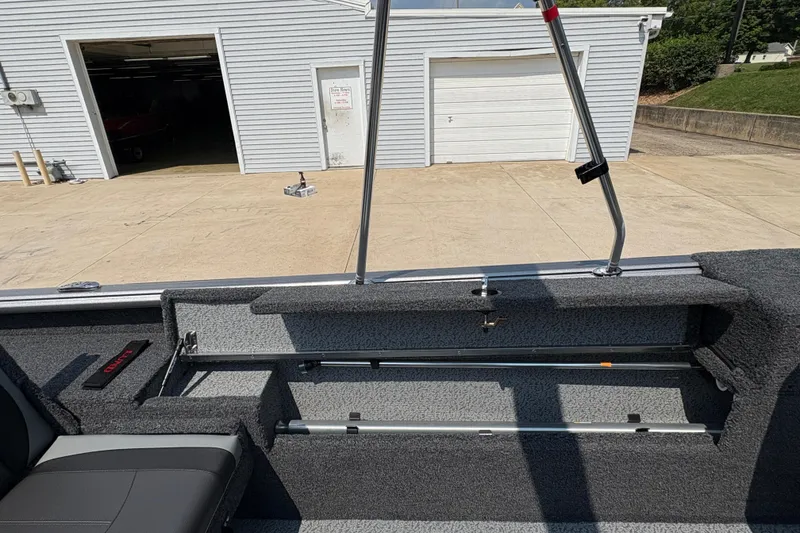Slide: The Image of 2026 Lund 1875 Impact XS Sport boat interior with storage compartments and seating. - 25