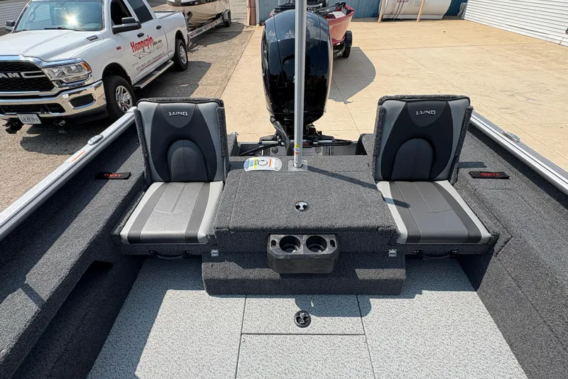 Slide: The Image of 2026 Lund 1875 Impact XS Sport boat interior with two seats and motor. - 26