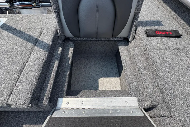 Slide: The Image of 2026 Lund 1875 Impact XS Sport boat interior storage compartment, gray upholstery. - 30