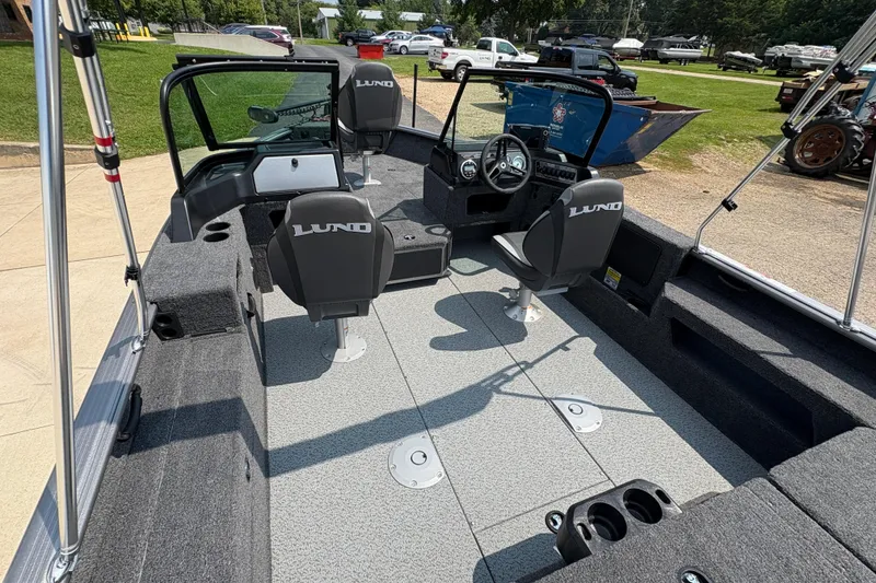 Slide: The Image of 2026 Lund 1875 Impact XS Sport boat interior with seating and steering console. - 31