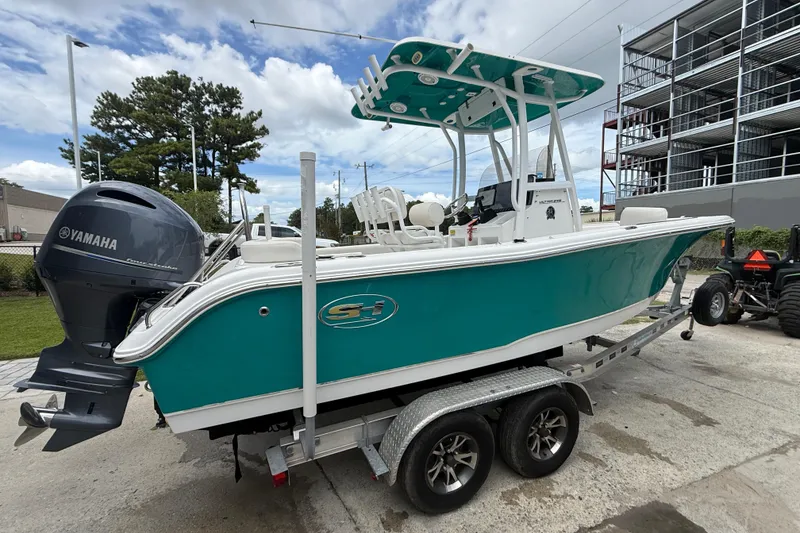 Slide: The Image of 2021 Sea Hunt Ultra 219 boat on trailer with Yamaha outboard motor. - 11
