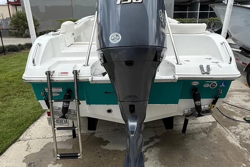 Slide: The Image of 2021 Sea Hunt Ultra 219 boat with outboard motor and swim ladder. - 21