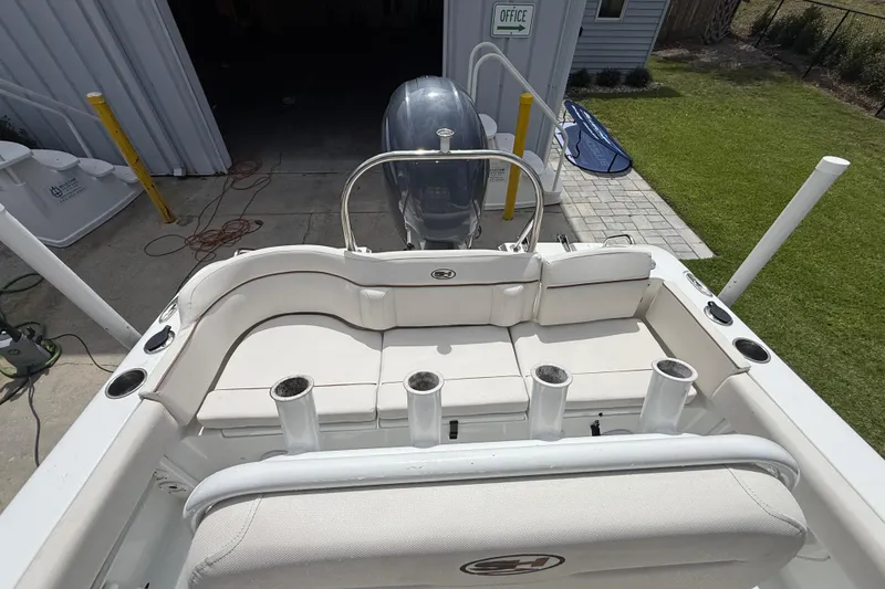 Slide: The Image of 2021 Sea Hunt Ultra 219 boat interior with seating and rod holders. - 27