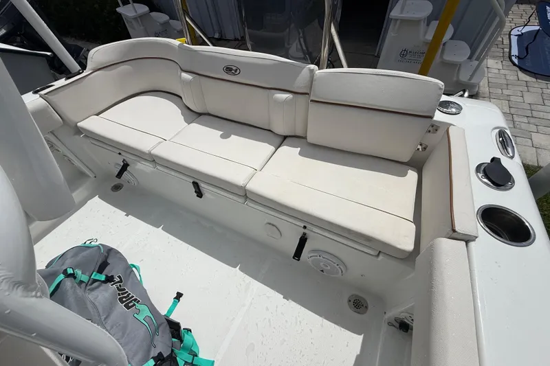 Slide: The Image of 2021 Sea Hunt Ultra 219 boat interior with cushioned seating and storage compartments. - 29