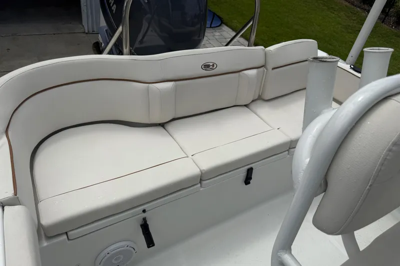 Slide: The Image of 2021 Sea Hunt Ultra 219 boat interior with white cushioned seating. - 30