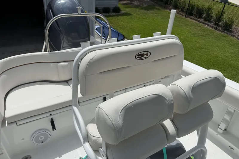 Slide: The Image of 2021 Sea Hunt Ultra 219 boat interior with a duffel bag and visible footwear. - 32