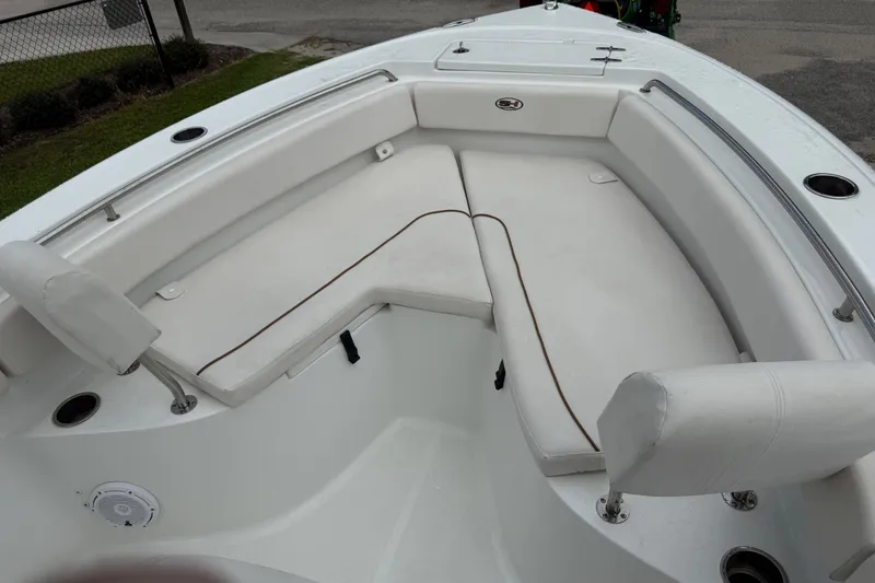 Slide: The Image of 2021 Sea Hunt Ultra 219 boat interior with white cushioned seating. - 35