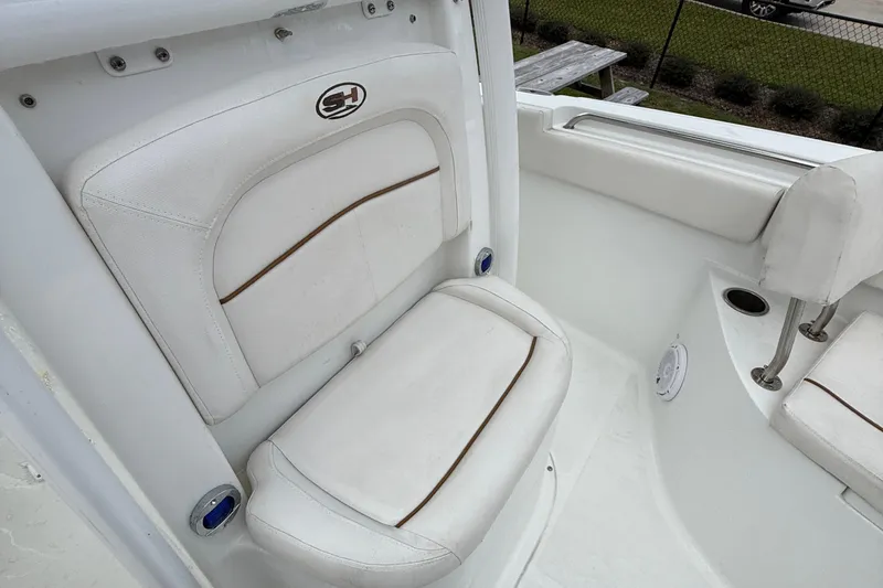 Slide: The Image of 2021 Sea Hunt Ultra 219 boat seat with white upholstery and logo detail. - 36