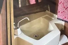 Slide: The Image of 1986 O'Day 272 sailboat interior sink with faucet and storage. - 8