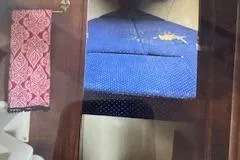 Slide: The Image of Interior cabin view of a 1986 O'Day 272 sailboat with blue upholstery and patterned towel. - 9