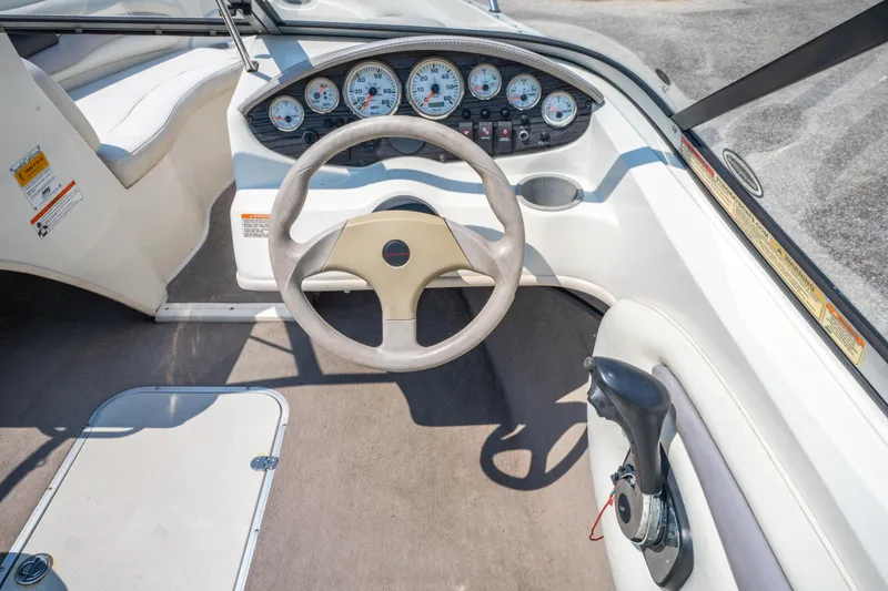 Slide: The Image of 2010 Stingray 195LX boat dashboard with steering wheel and instrument panel. - 14