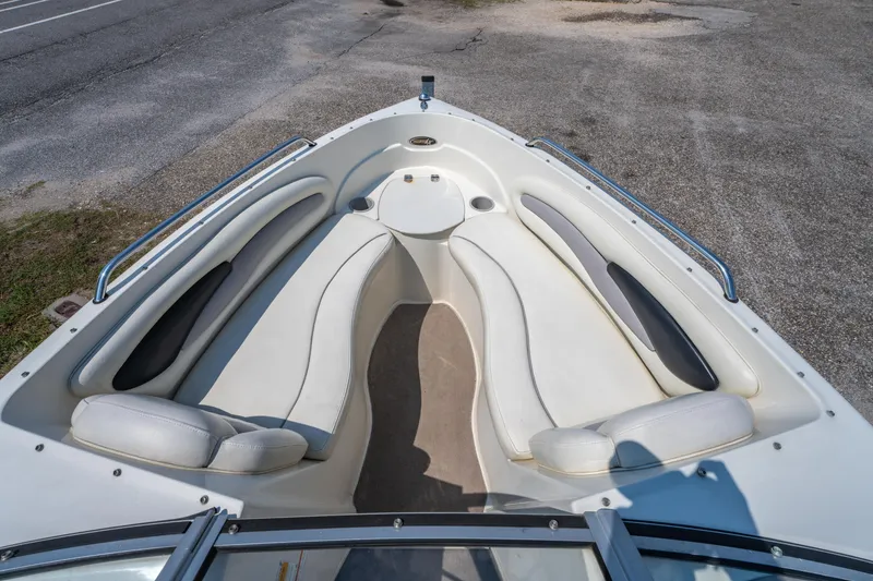 Slide: The Image of 2010 Stingray 195LX boat interior with white seating and cup holders. - 17