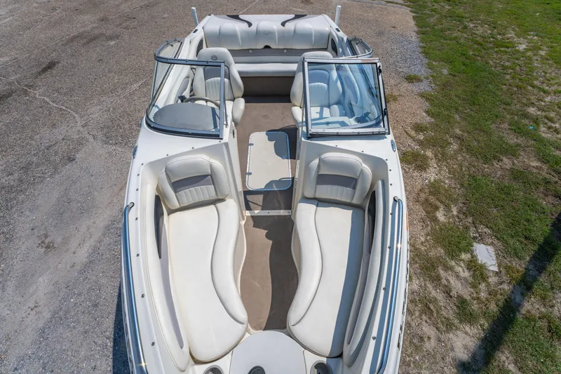 Slide: The Image of 2010 Stingray 195LX boat interior with white seating and open deck layout. - 18