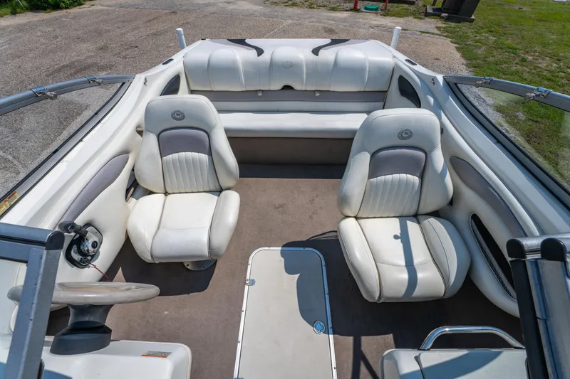 Slide: The Image of 2010 Stingray 195LX boat interior with white seating and steering wheel. - 19