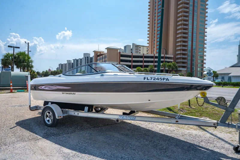 Slide: The Image of 2010 Stingray 195LX boat on trailer, urban background, sunny day. - 21
