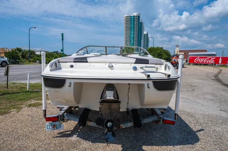 Slide: The Image of 2010 Stingray 195LX boat on trailer, urban background, Coca-Cola truck visible. - 5