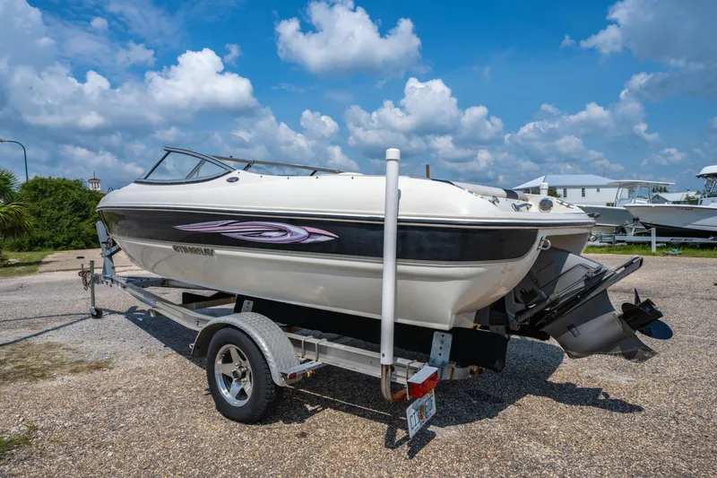 Slide: The Image of 2010 Stingray 195LX boat on trailer under a bright blue sky. - 6