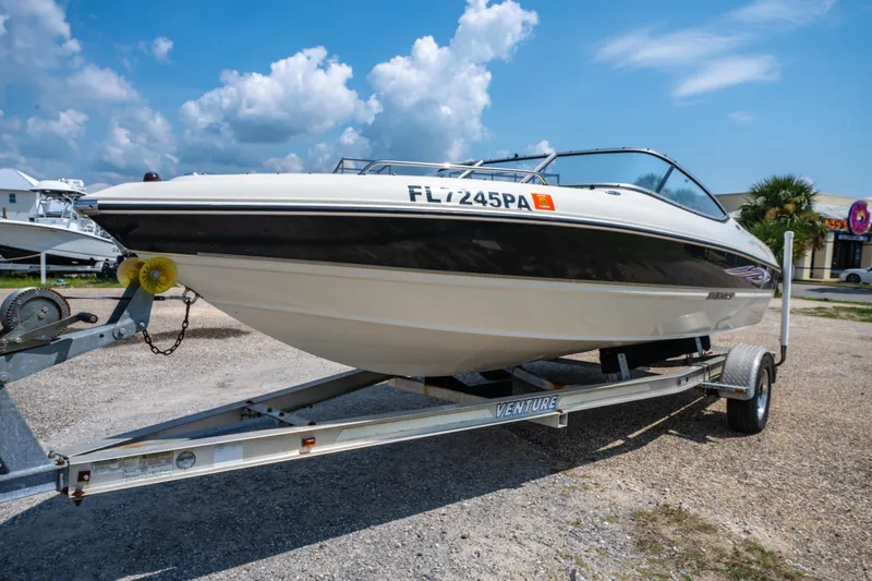 Slide: The Image of 2010 Stingray 195LX boat on trailer under a clear blue sky. - 8