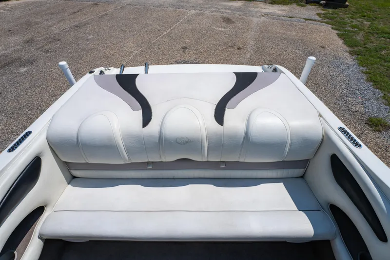 Slide: The Image of 2010 Stingray 195LX boat interior with white and black seating on a sunny day. - 9