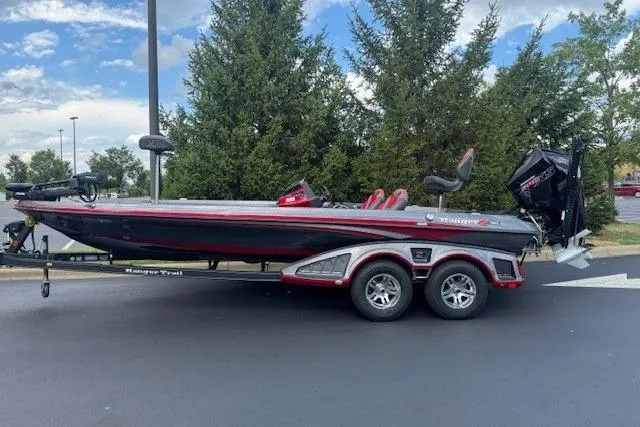 The Image of 2019 Ranger Z521L bass boat on trailer, parked outdoors with trees in background. - 0