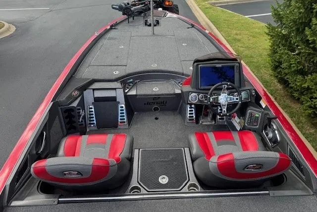 Slide: The Image of 2019 Ranger Z521L boat interior with red and gray seats, steering console, and navigation equipment. - 1