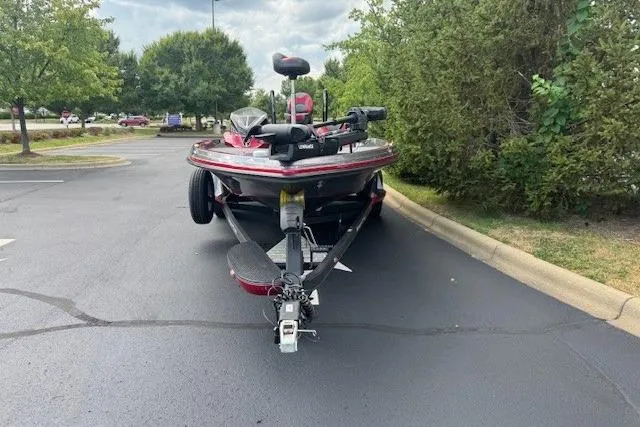 Slide: The Image of 2019 Ranger Z521L boat parked on asphalt, surrounded by trees and greenery. - 4
