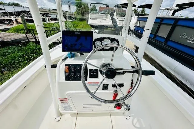 Slide: The Image of 2023 Mako 18 LTS boat dashboard with steering wheel and navigation system. - 14