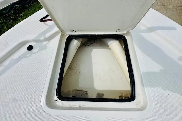 Slide: The Image of Open storage compartment on 2023 Mako 18 LTS boat deck. - 21