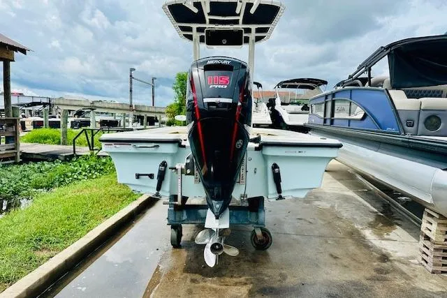 Slide: The Image of 2023 Mako 18 LTS boat with Mercury 115 Pro XS engine at a marina. - 3